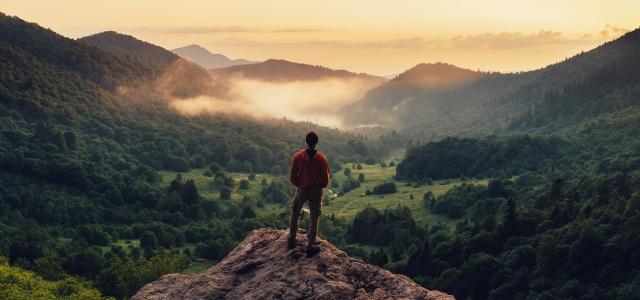 Man standing on top of a mountain